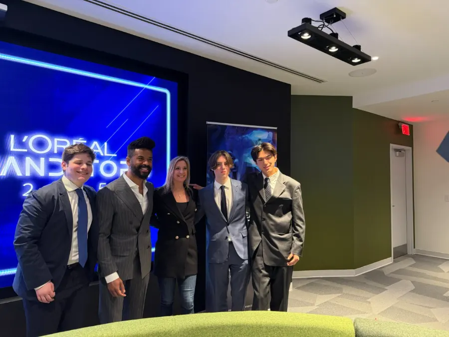 Team LooksMax at L'Oréal Brandstorm USA 2025, standing in front of the L'Oréal Brandstorm screen.
